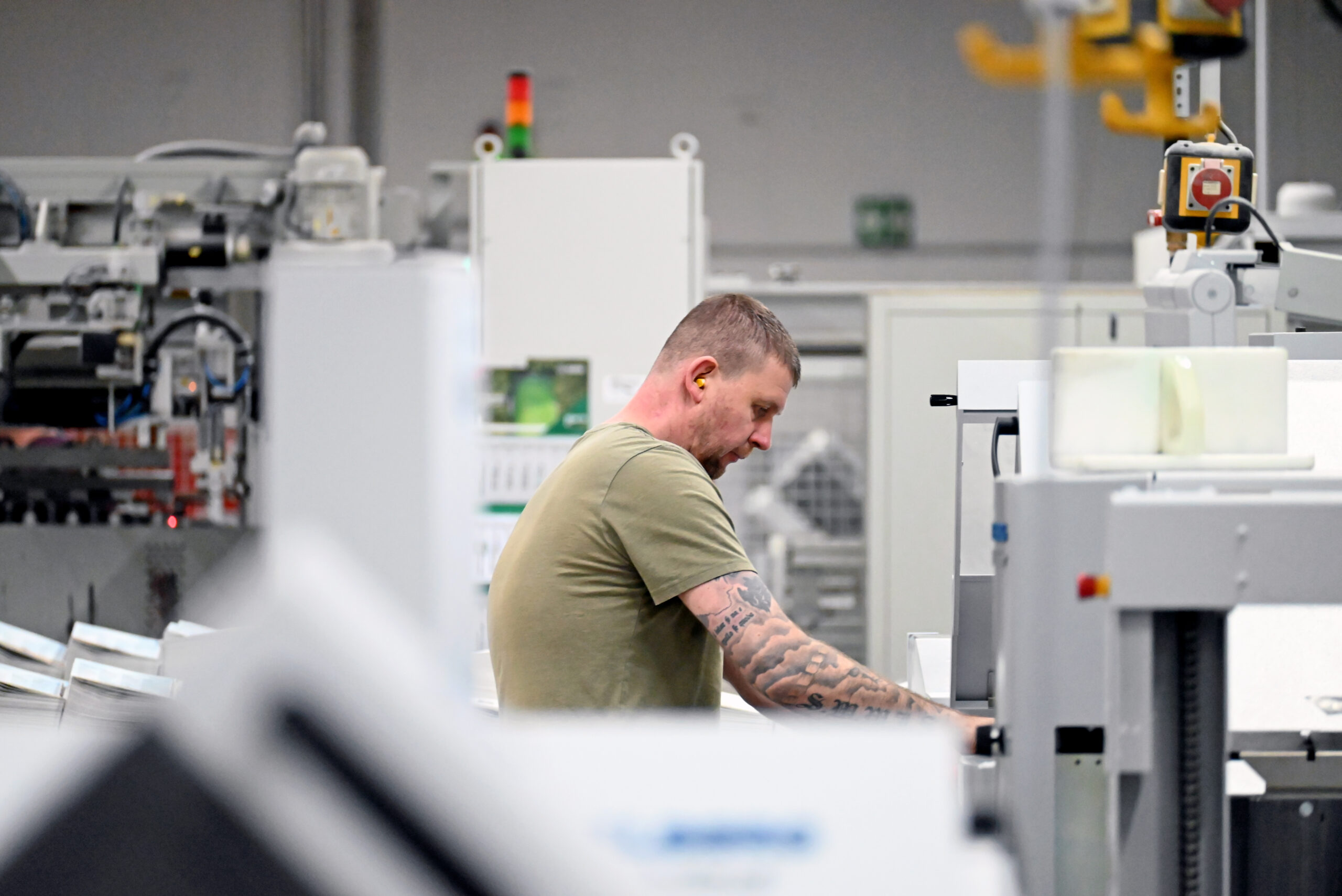 Mitarbeitender an Druckmaschine